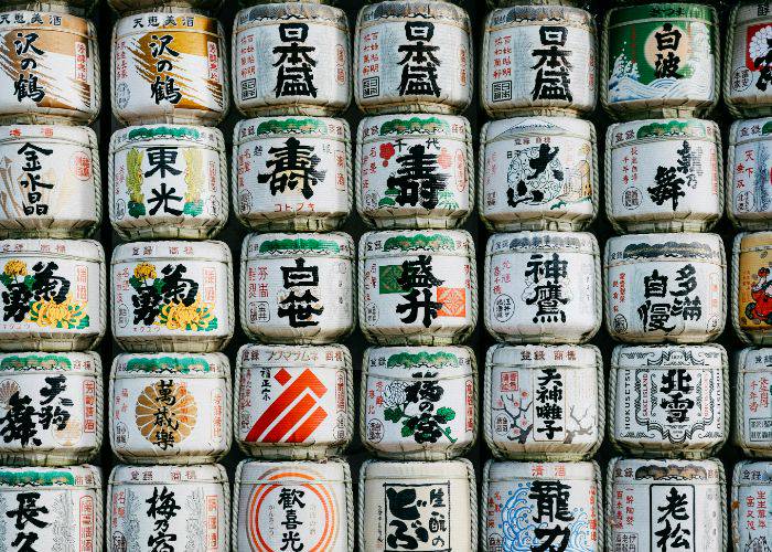 A collection of sake barrels, stacked high and filling the shot.
